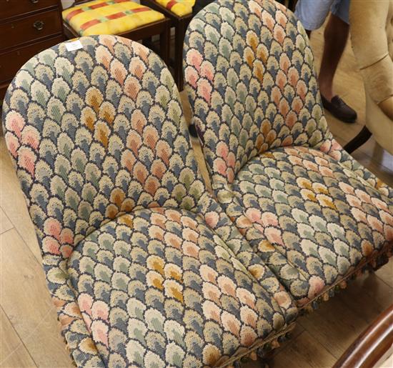 A pair of Victorian rosewood tapestry upholstered nursing chairs
